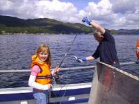 Young guest catching her first fish Young guest catching her first fish